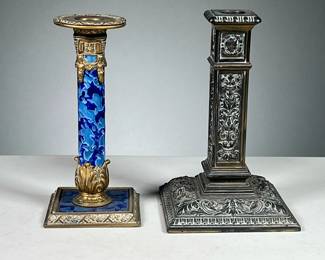 (2pc) Interesting Brass Candlesticks | Includes: a blue enameled and brass candlestick with floral motif in the base, and one intricately decorated brass pillar candlestick with various portrait relief. - h. 7 in