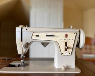 Singer 237/239 with manual and walnut cabinet.