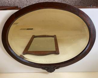 Elegant oval mirror with a classic wooden frame. Simple yet timeless.