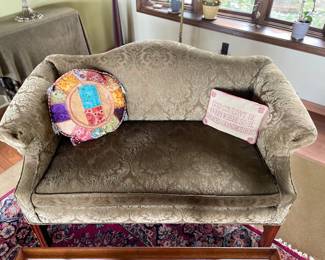 Elegant settee featuring graceful curves is ready for its next round of life—perfect for those looking to restore it to its former glory and add a touch of sophistication to any room.