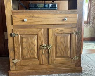 Beautiful White Clad reproduction TV stand in excellent condition, featuring classic ice box-inspired design and quality craftsmanship. This versatile unit combines vintage charm with modern functionality, complete with brass hardware and solid construction. Perfect for adding a touch of nostalgia and character to your living space.