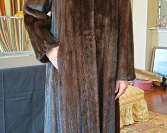 Full length Black Gamma mink cost is dark but looks brown in this photo. Size Small-Medium. Julian Gold label.