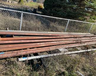 20ft Flag Pole in foreground. Behind are 20 to 30 ft long steel poles.