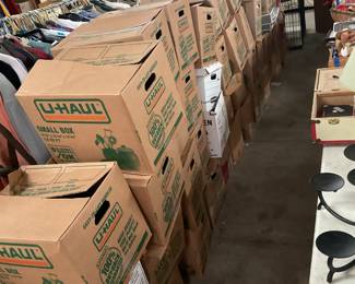 All of the U-Haul boxes are filled with books. 