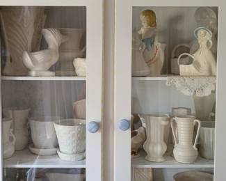 Hand-painted cabinet with lots of pottery