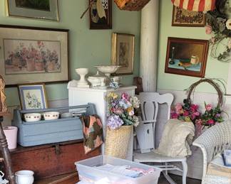 The she shed filled with furniture Primitives hand-painted items linen and whatnot or I should say knick knacks