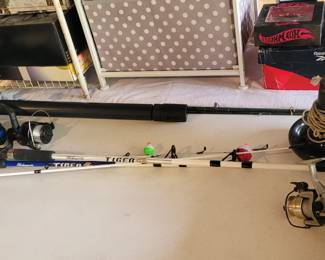 Some fishing poles anchor and lures and some kind of fish finder