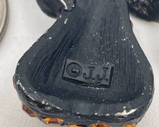 Close up of vintage J.J. Jonette pear brooch, enameled metal and pavé set amber color rhinestones