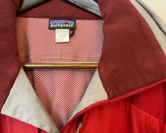 Closeup of Patagonia women's outerwear red hooded zipper front jacket, size L