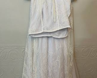 Another view of cream and white embroidered matching top with rhinestones and Faux Pearls at the waist, with matching white embroidered overlay skirt