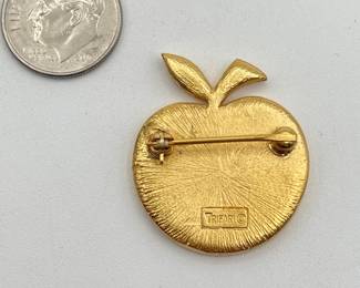 Reverse of Crown Trifari apple brooch, shimmering green in gold tone frame