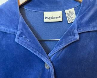 Closeup of Appleseed's blue velour long sleeved button front top with matching skirt, size M