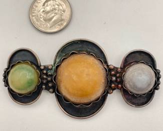 Mexican silver brooch with three differently colored hard stones or glass; gifted to original owner in 1957