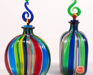 Pair of vibrant Murano glass decanters with stylized curved stoppers. Made in Italy, original labels.