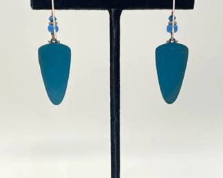 Reverse view of blue bead and painted metal pierced earrings