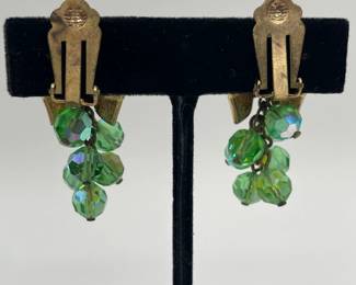 Reverse view of vintage Aurora Borealis green crystal dangle earrings and matching brooch, gold tone metal