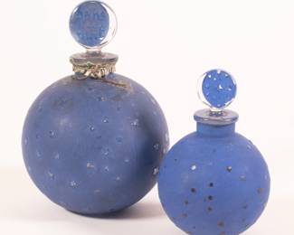 Pair of Lalique "Stars" Dans la Nuit post-war glass perfume bottles, decorated with a clear and frosted blue foundation with cut to clear stars. Lalique France mark on base, numbers etched in stoppers' tips. Bottle designed by Lalique for House of Worth. 