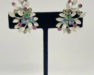 Pair of BSK clip earrings, silver tone metal with white enamel leaf shapes and jewel cut glass pieces in pink, ice blue, and spring green