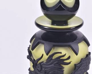 Closeup of Barry Sautner signed art cameo glass stoppered yellow bottle with black dragon design, numbered 00014