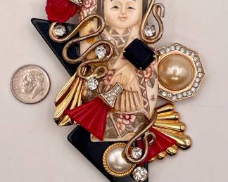 Vintage Asian maiden brooch; mixed media collage includes carved bone or resin, faux pearls, rhinestones, gold toned metal, and scarlet Bakelite or Lucite rose and fans