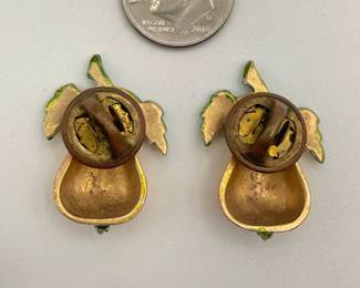 Reverse view of pair of enameled lapel pins in the form of a yellow-gold pear and green leaves