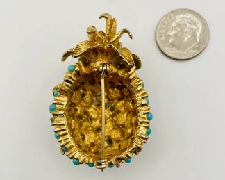 Reverse view of pineapple brooch in gold-tone metal with turquoise color beads.