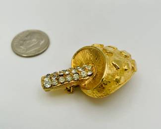 Side view of very cute dimensional mushroom brooch, gold color over metal, with clear rhinestones