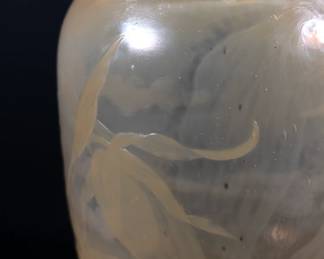 Closeup of Émile Gallé Nancy signed art glass vase, pale gold color with graceful floral design