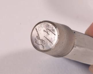 Closeup of tip of the stopper in one of the pair of Lalique "Stars" Dans la Nuit post-war glass perfume bottles, decorated with a clear and frosted blue foundation with cut to clear stars. Lalique France mark on base, numbers etched in stoppers' tips. Bottle designed by Lalique for House of Worth. 