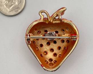 Reverse view of vintage enameled and rhinestone strawberry brooch