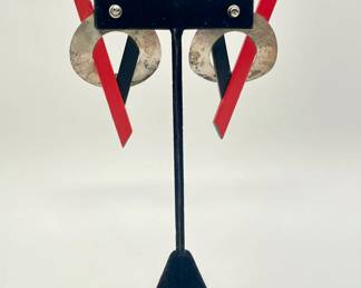 Reverse view of pair of red and black painted wood and silver circle pierced earrings (possibly sterling).