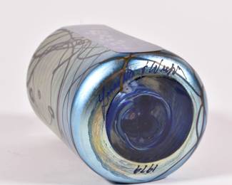 Base of beautiful art glass paperweight, iridescent exterior with cut to clear panel showing interior millefiori blossoms; signed by artist, 1979