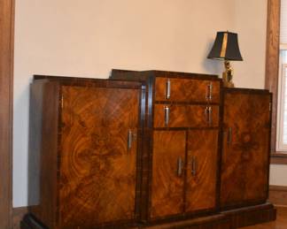 Another view of the Art Deco sideboard, part of the custom dining room set by Long & Wexlear of Australia - the dynamic stepped top, burled wood and chrome hardware adds an industrial touch, further enhancing the set’s luxurious feel.