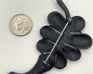 Reverse view of PELL leaf brooch, graceful curved black enameled frame with deep pink faceted rhinestones