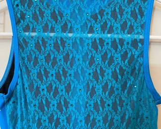 Closeup of back of blue one piece, zip front, rhinestones