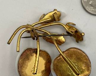 Reverse of vintage Austria milk glass cherries and leafs brooch, set in gold tone metal, marked Austria on the back. 