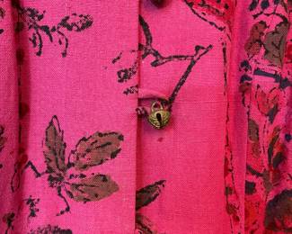 Closeup of women's long sleeve button front patterned top - deep pink with floral pattern, Mandarin style collar, bells for buttons