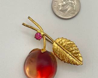 Single cherry brooch, with pink crystal and frosted two-toned glass cherry, gold toned metal leaf and stem, marked AUSTRIA