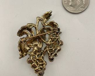 Reverse view of 1950s grape cluster brooch, enameled metal with yellow and green rhinestones