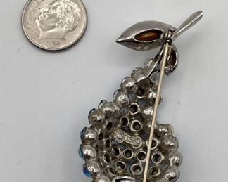 Reverse of BSK pear brooch, with faceted blue and clear crystals. BSK was founded in New York in 1948 and made costume jewels until the 1980s. The letters BSK brought together the initials of the founders, Benny Steinberg, Slovitt and Kaslo.