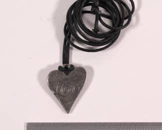 Silver-toned metal stylized heart pendant on black cord necklace
