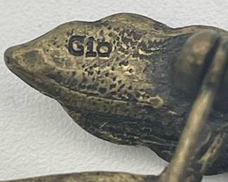 Closeup of Gio pear shape brooch, blackened metal and pale rhinestones