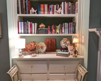 One of two built-in bookcases in the den, with nice collection of new/old books, pair of bookcase lamps, one is a sweet pair of vintage French boudoir lamps, w/porcelain figurines and flowers. 