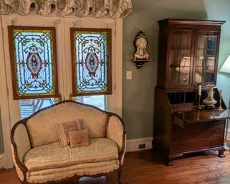 Vintage needlepointed wool bell pull,  upholstered French love seat, pair of matched stained glass panels, vintage, wall-mounted Swiss-made Zenith court-style vintage table clock and  vintage mahogany secretary,  by Biggs furniture Co.