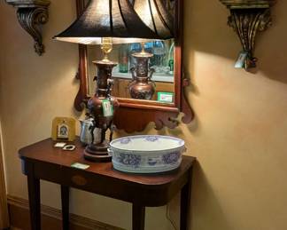 1930's inlaid mahogany side table, w/bronze Asian table lamp, 1930's mahogany Chippendale style wall mirror, pair of wall sconces w/antique English porcelain vases, English transferware oval bowl and brass planter with lion heads.