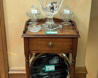 Vintage wooden English smoking stand, w/crystal drink dispenser, pair of bee motif honey jars, Waterford ring holder and brass/glass lighthouse fresnel, at the bottom.