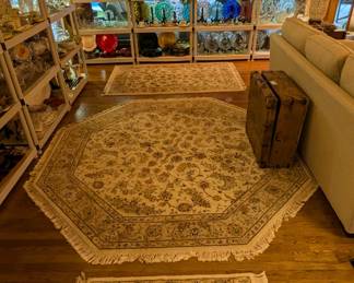 View of the great room, as you enter the house from the foyer, to see three matched hand-woven Persian Tabriz designed rugs, a cool ol' wooden treasure box and an amazing amount of stemware and hostess with the mostess items.