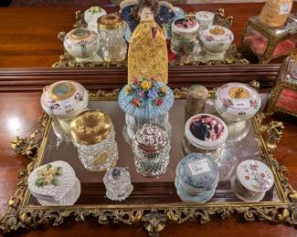 Close-up of the vintage brass-framed mirrored vanity tray with everyday needful things. 