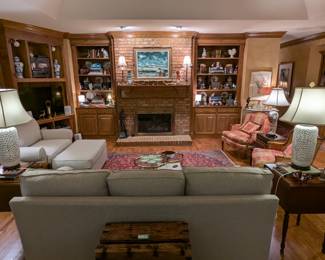 Great room with sofa and matching loveseat/ottoman, by Cindy Crawford Home, pair of 1930's mahogany two-drawer drop-leaf side table, by Biggs Furn. Co., (Richmond, VA), pair of white porcelain Asian table lamps, vintage, hand-woven Persian rugs, bookcases full of vintage books and cast iron collection and pair of 1930's mahogany two-drawer drop-leaf side table, by Biggs Furn. Co., (Richmond, VA), pair of matching stained glass panels.