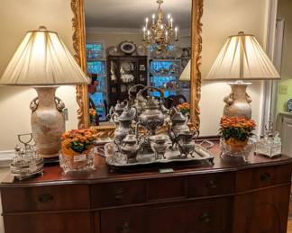 Delicious 1930's mahogany sideboard, with pair of lovely pomegranate Asian porcelain table lamps, 7-piece English silver plated tea/coffee set and vintage gilt wood (not composite) wall mirror.